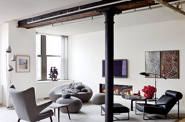 industrial style living space with fireplace and modern furniture.  