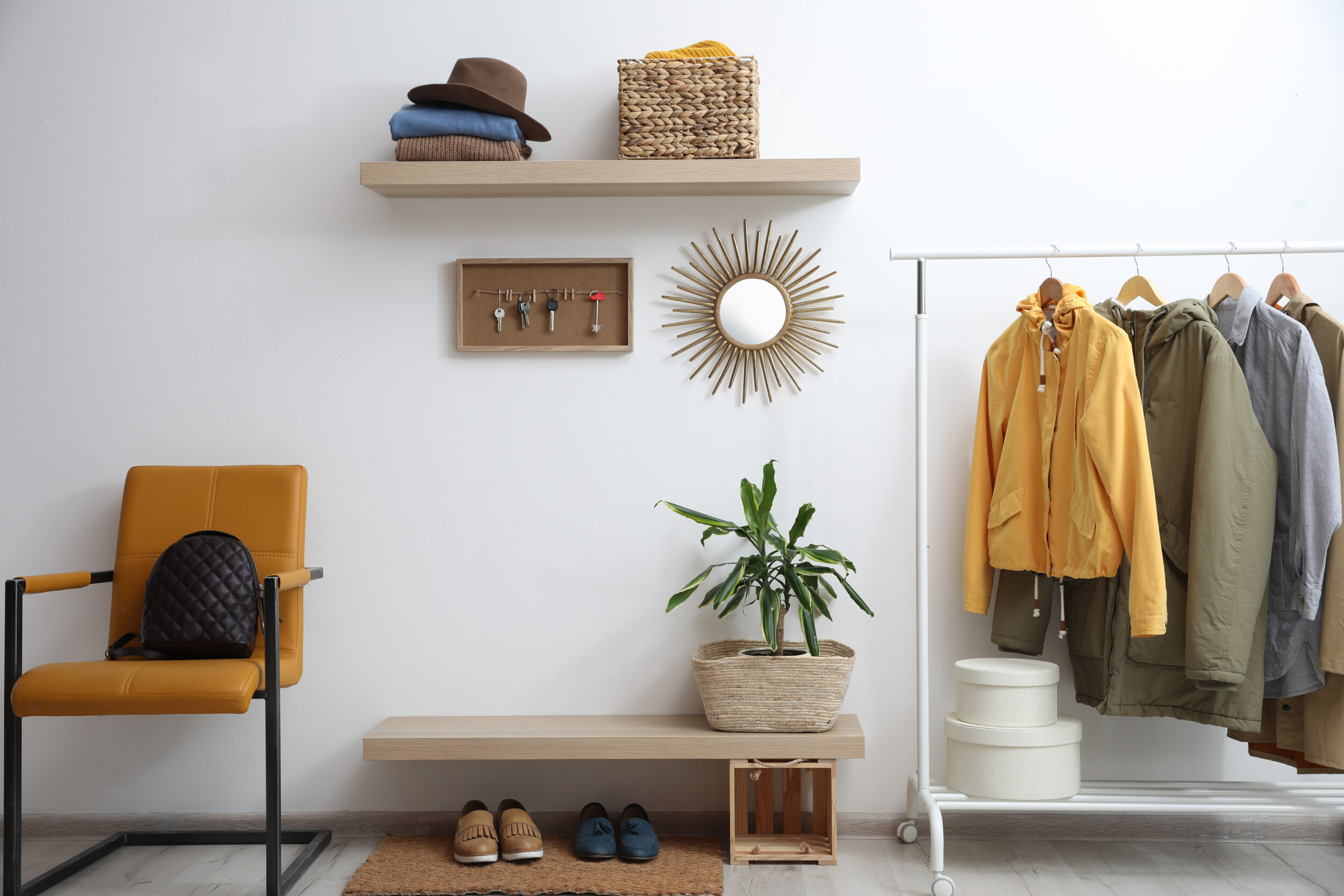 Hallway interior with stylish furniture, clothes and accessories