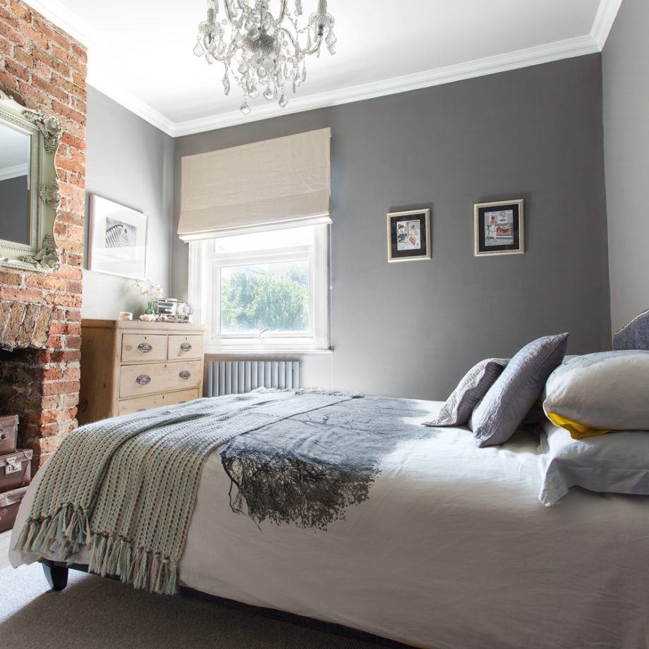 grey bedroom design with brick