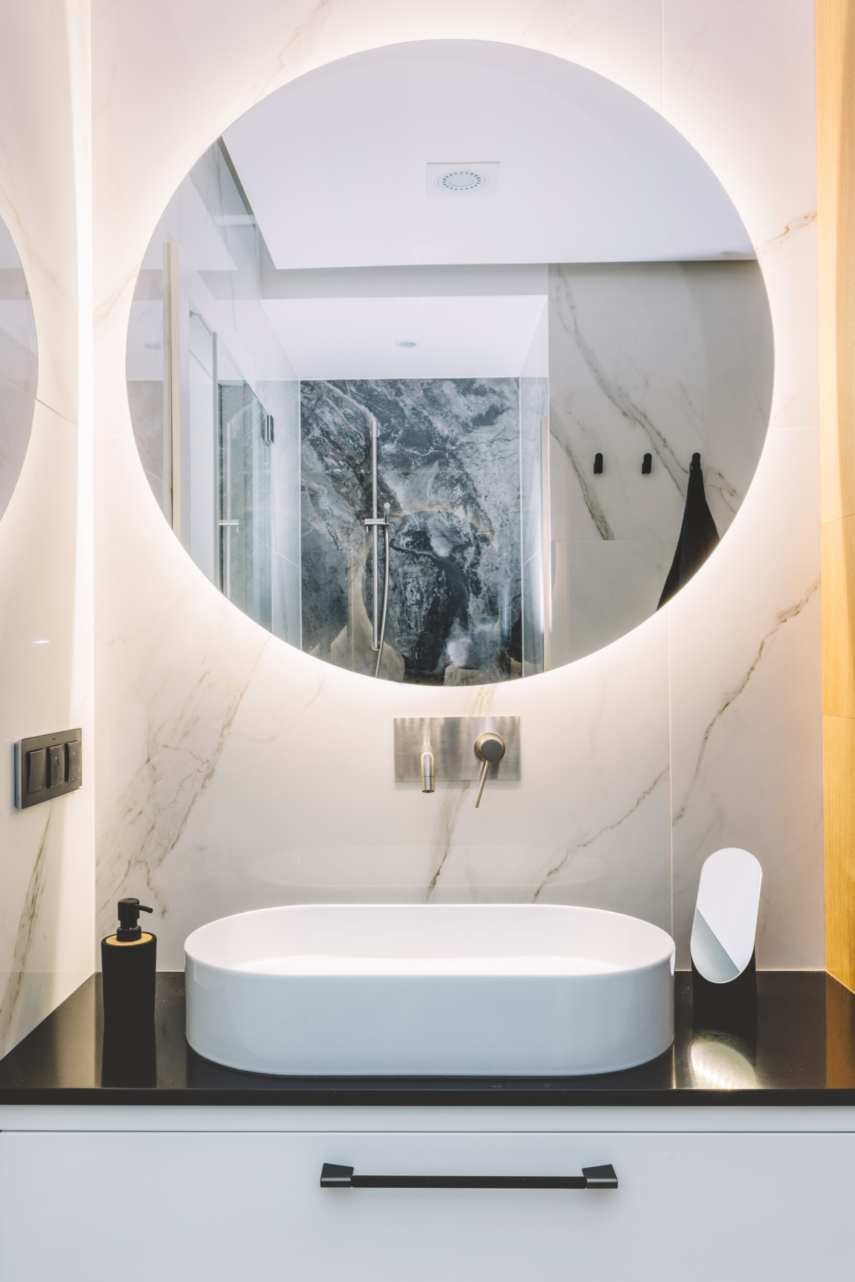 modern bathroom with round mirror