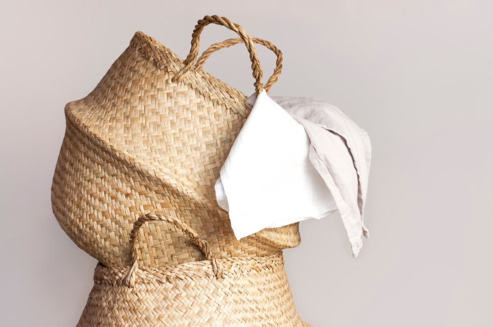 Straw wicker basket and white natural cotton fabric