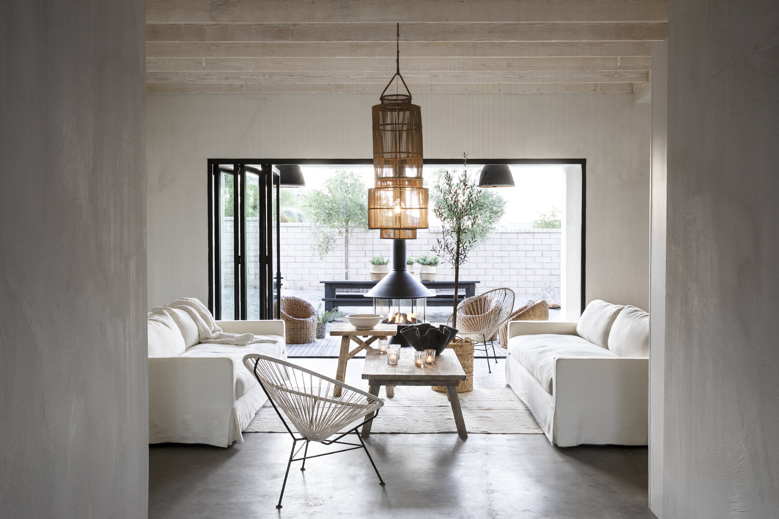 Modern farmhouse living room with raw wood ceiling beams 