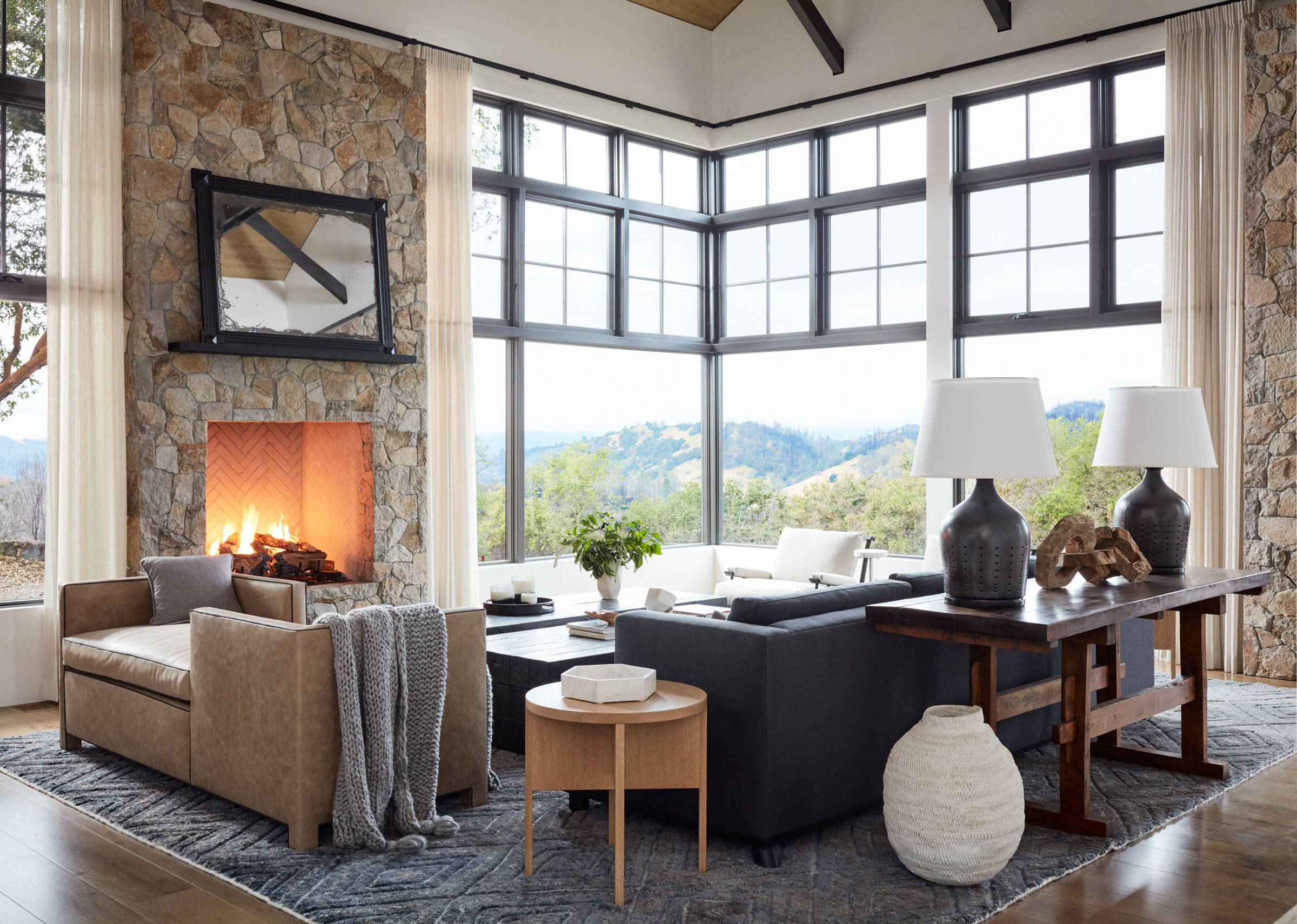 Modern farmhouse living room with stone fireplace 
