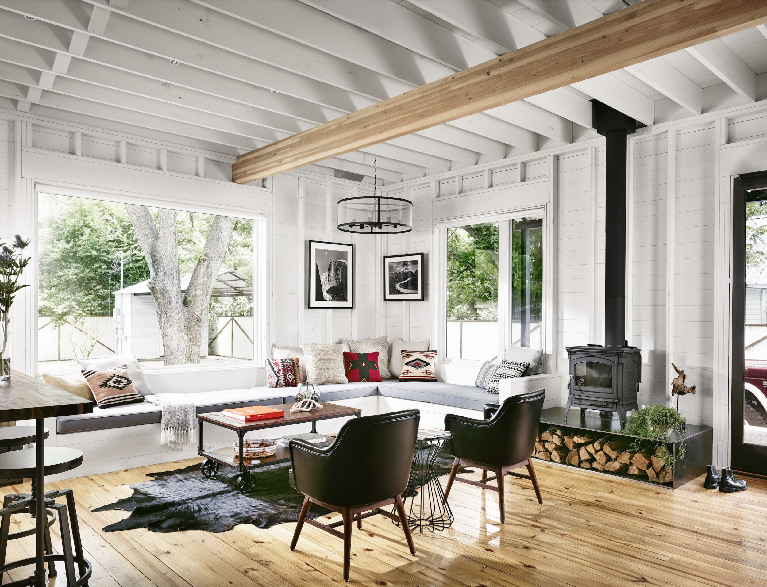 Modern living area with wood stove and hardwood floors