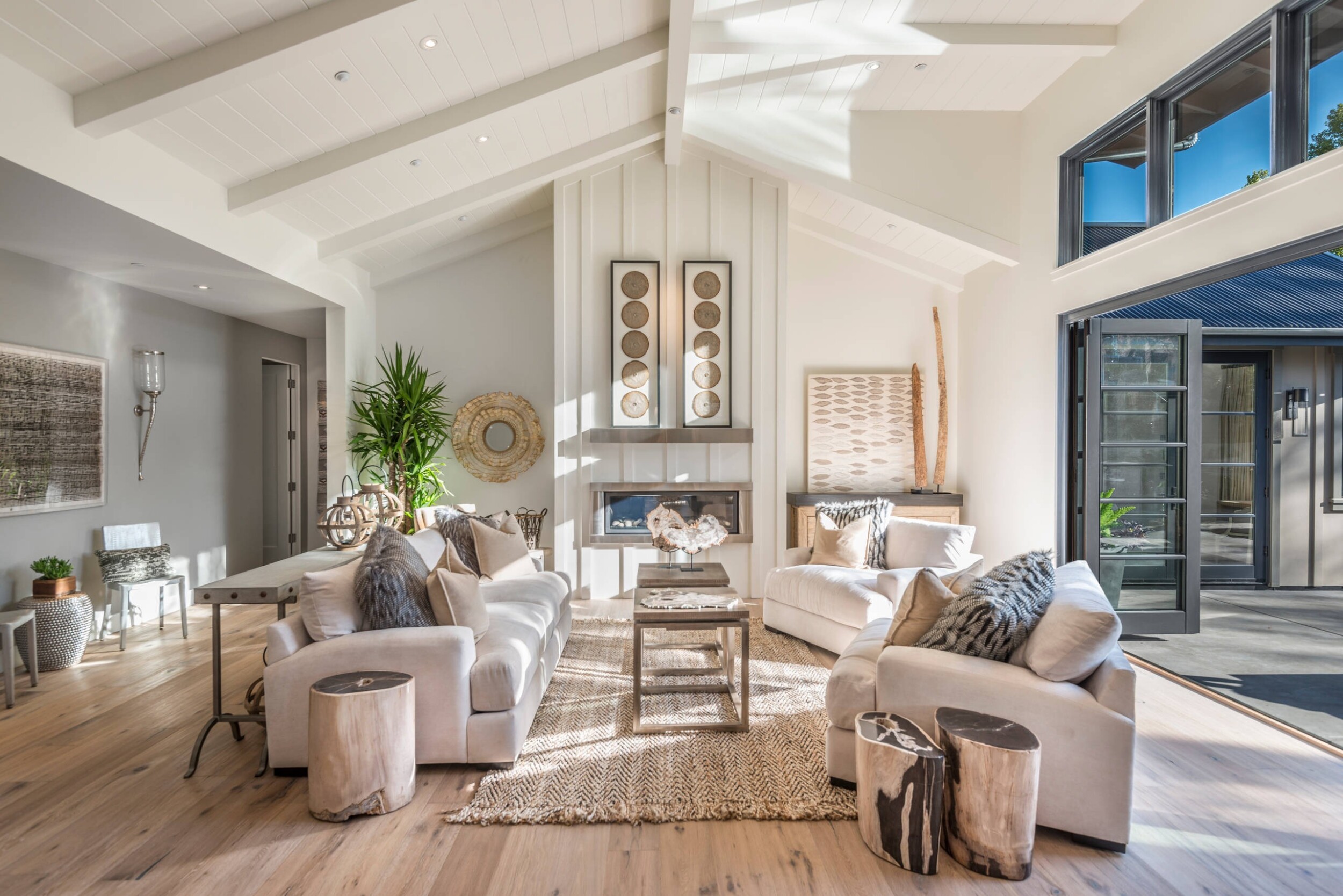 Modern living room with arched ceiling that opens up to outside 