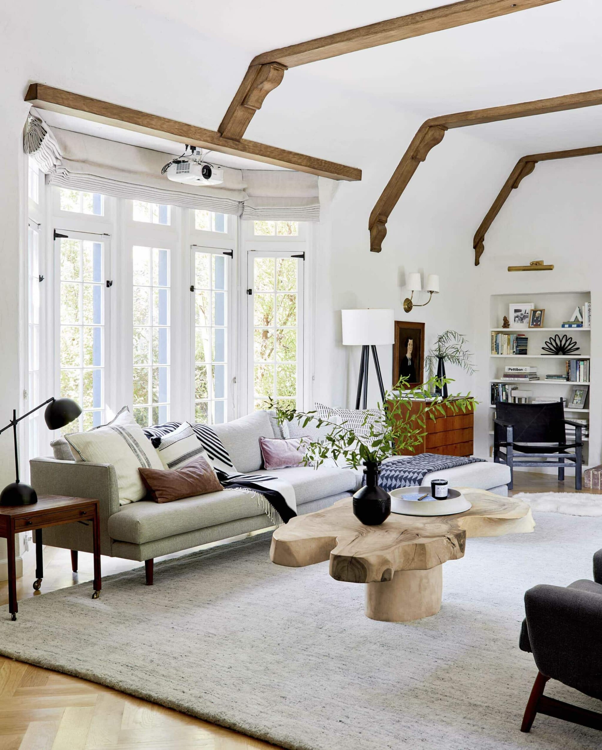 Modern living room with large window and timber coffee table 